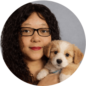Angela and holding a puppy